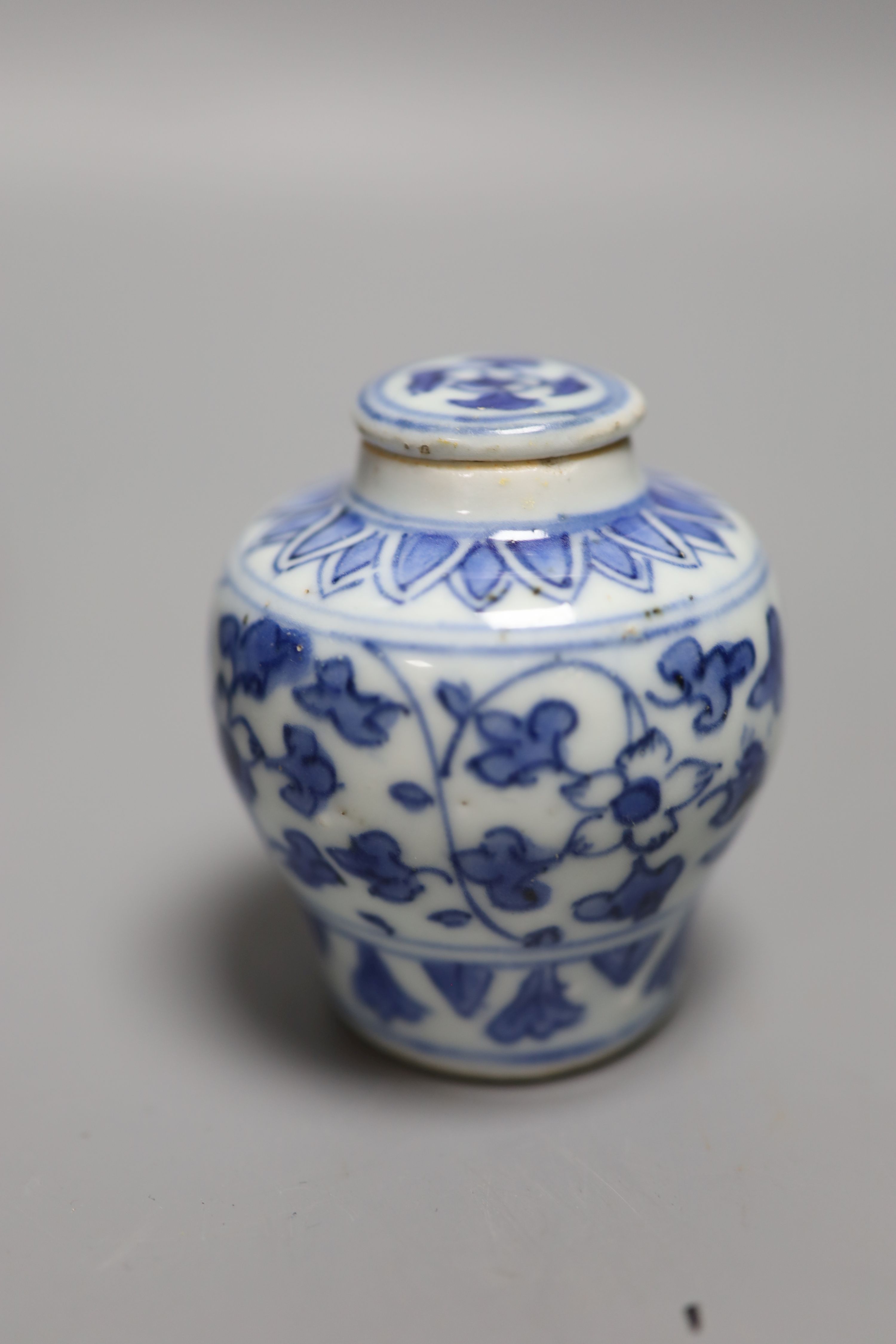 A Chinese blue and white lotus jar and cover, early 20th century, a similar dragon vase and a small Kangxi jarlet and cover, talles